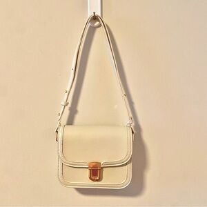 Beige bag with gold enclosure